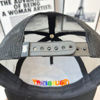 Black mesh cap interior with metal snap strap and eyelets