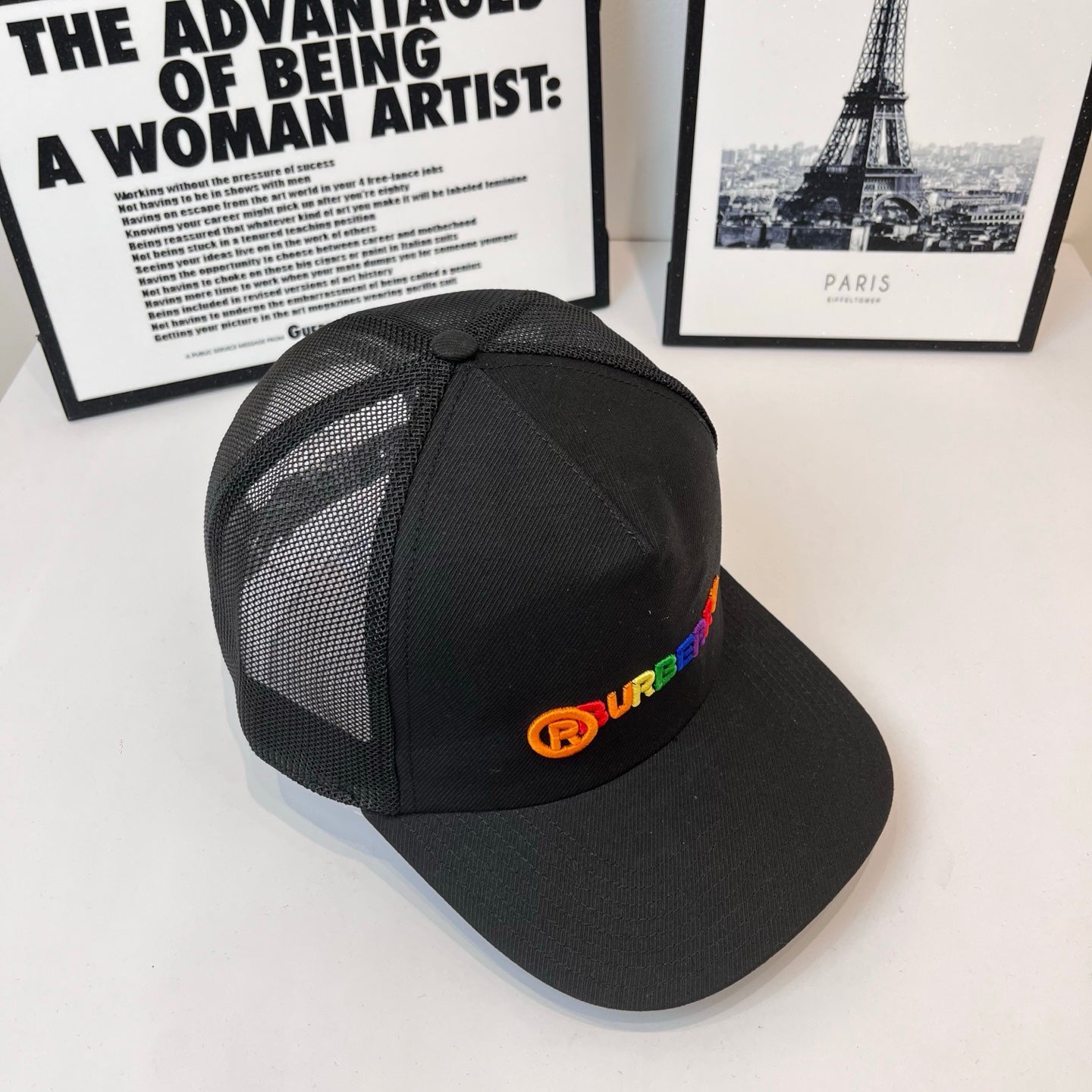 Black baseball cap with mesh side panels and colorful Burberry logo patch