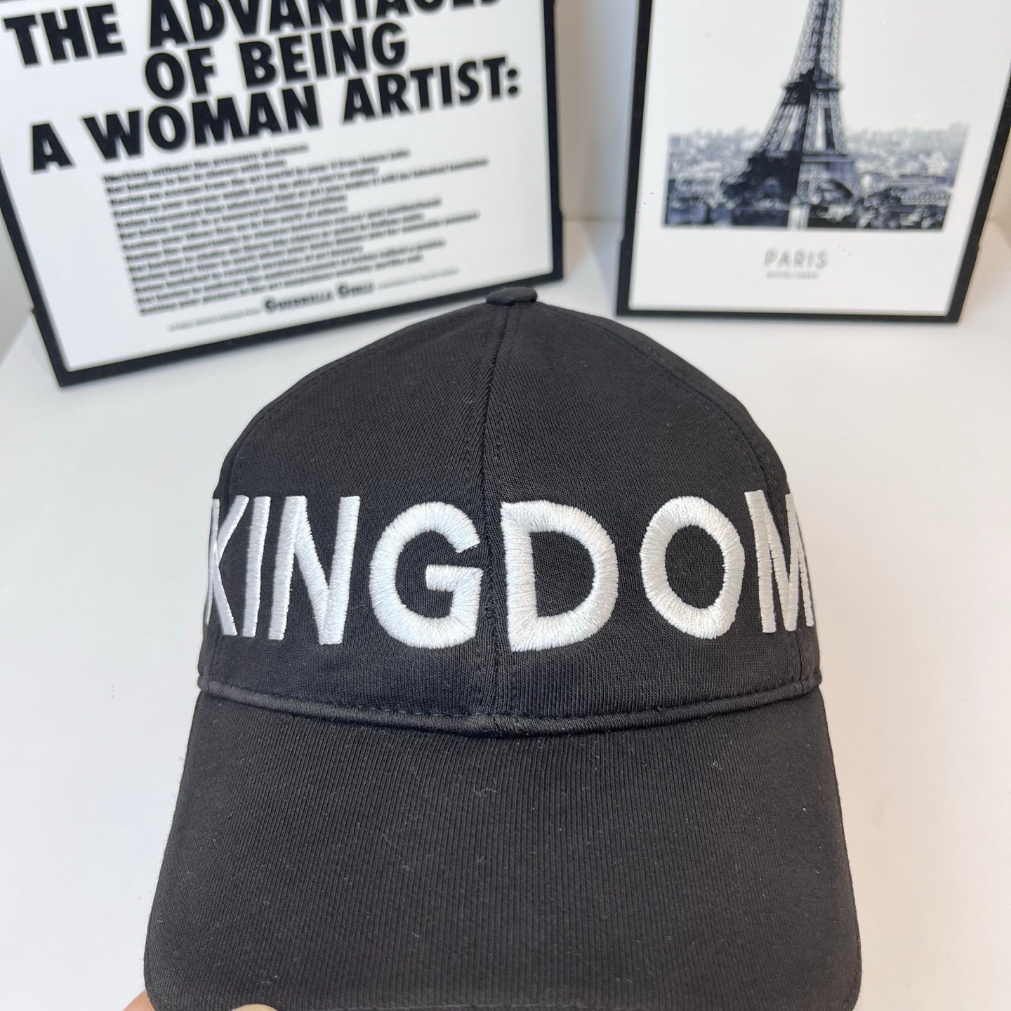 Black cap crown detail with 'KINGDOM' stitched lettering across front