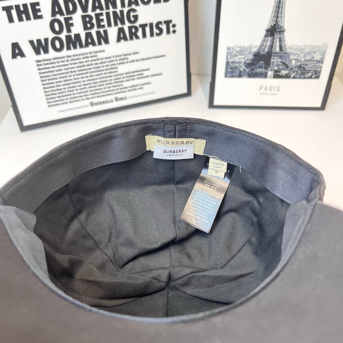 Gray cap interior with branded tags attached under brim