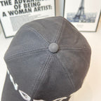 Gray fabric cap with round top button and stitched panel seams