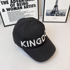 Black cap with KINGDOM embroidered text on curved crown