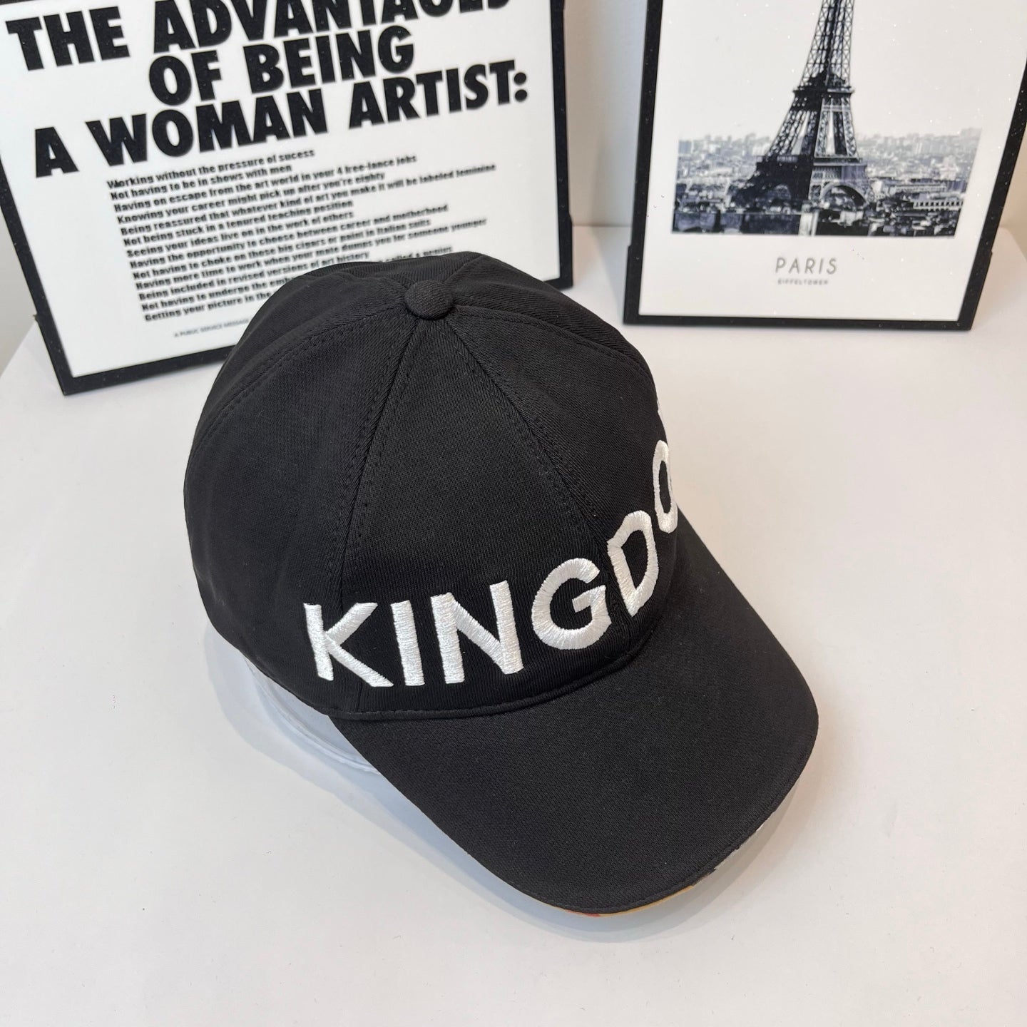 Black cap with KINGDOM embroidered text on curved crown