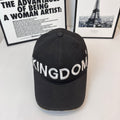 Black cap with 'KINGDOM' embroidered lettering across front