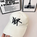 White canvas cap with black Dior logo on front, curved brim.
