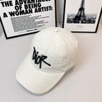 White canvas cap with black Dior logo on front panel.