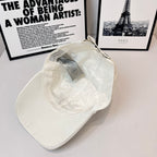 White canvas cap inside view with hanging tag and curved brim.