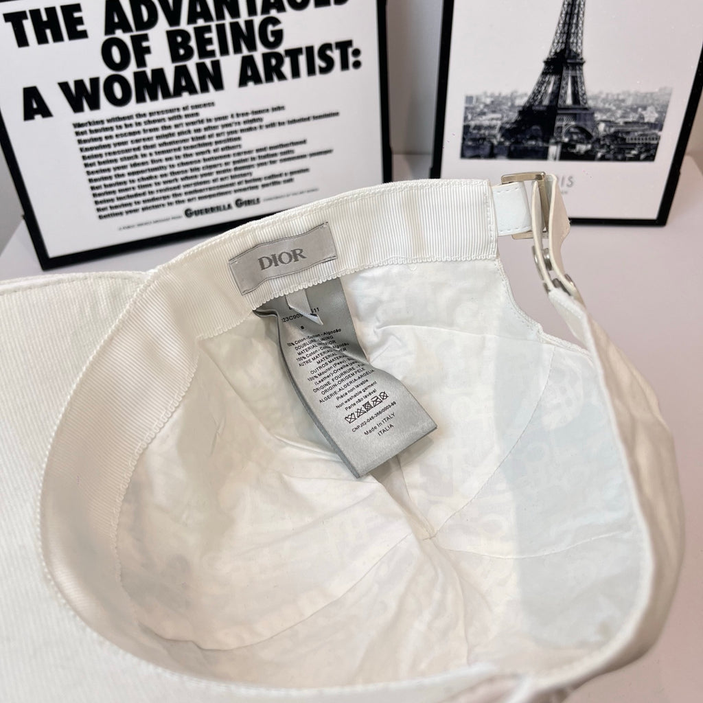 White canvas cap interior with Dior label and hanging size tag.