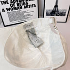 White canvas cap interior with Dior label and hanging size tag.