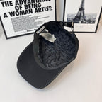 Baseball cap interior with dark patterned lining and adjustable strap