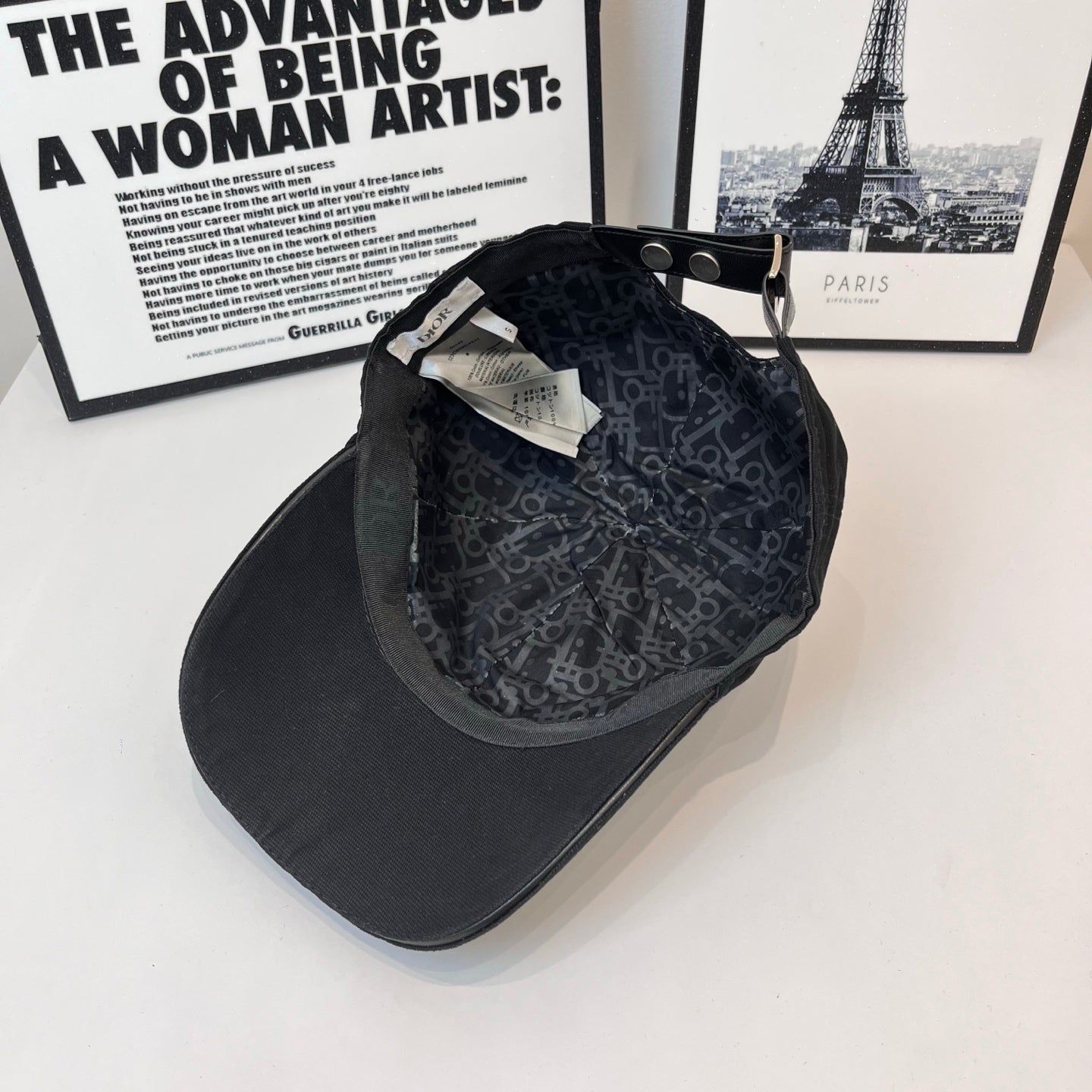 Baseball cap interior with dark patterned lining and adjustable strap