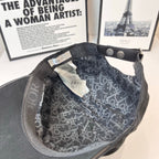 Cap interior with patterned lining, metal snap, and adjustable strap