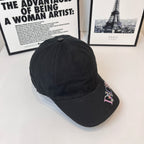 Dark cap with multicolor Dior logo on side and curved brim