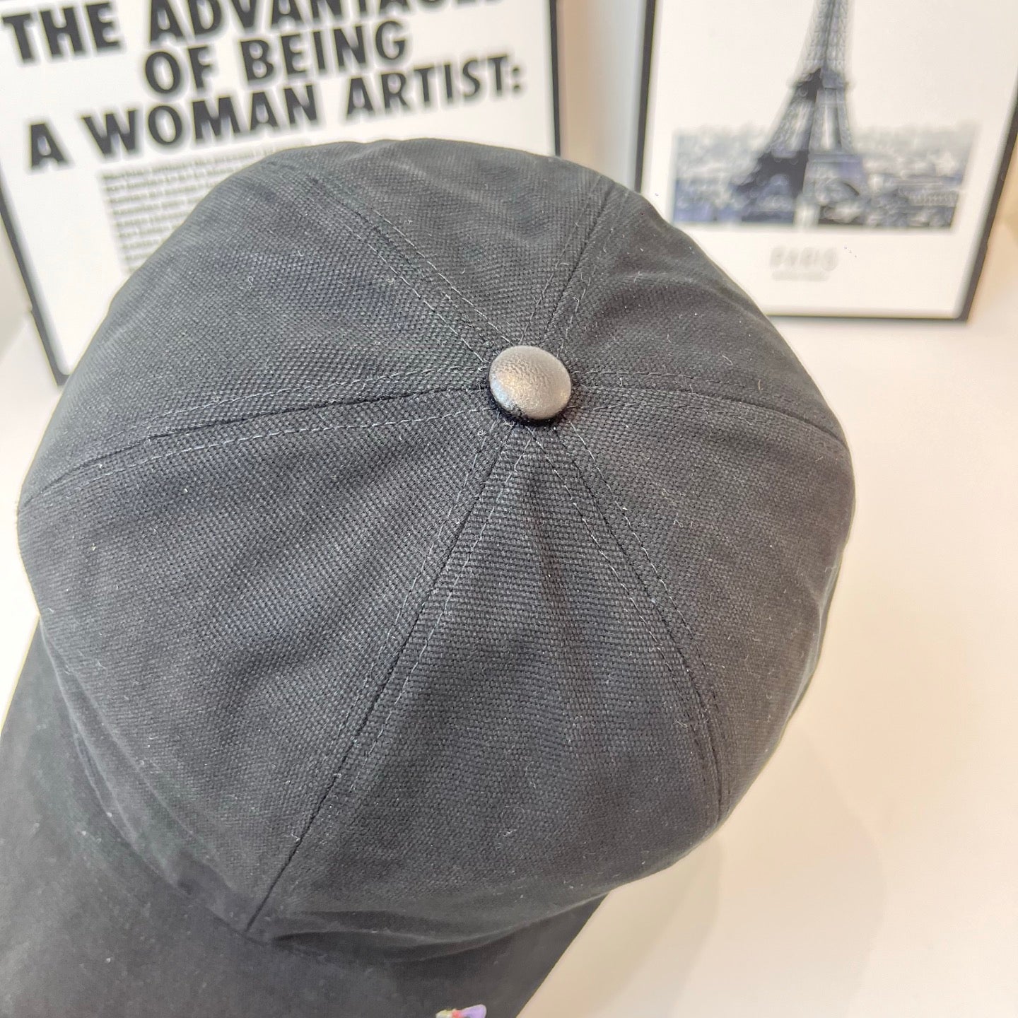 Gray baseball cap with round top button and curved brim