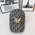Dior cap with navy-and-cream logo pattern, curved brim and front Dior lettering.