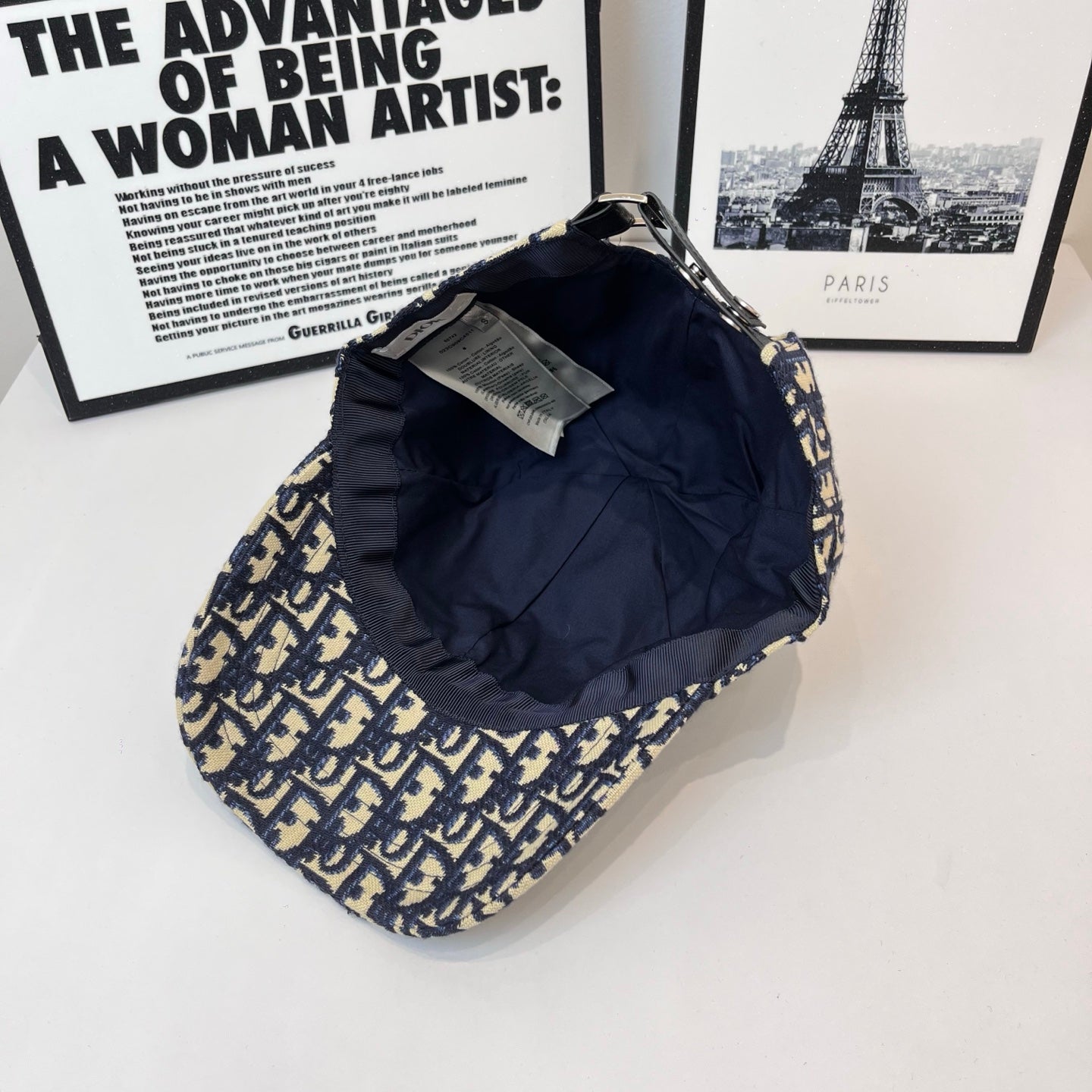 Dior cap with navy-and-cream logo print, back view with interior tags.