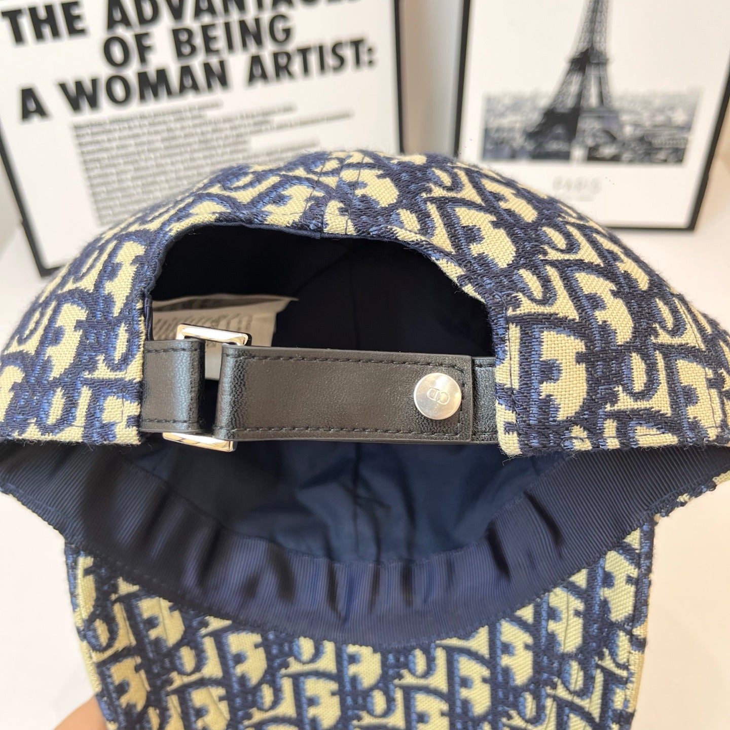 Dior cap interior with adjustable leather strap and metal buckle, open crown.