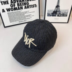 Dior monogram cap in dark navy with gold-tone Dior logo, angled front view
