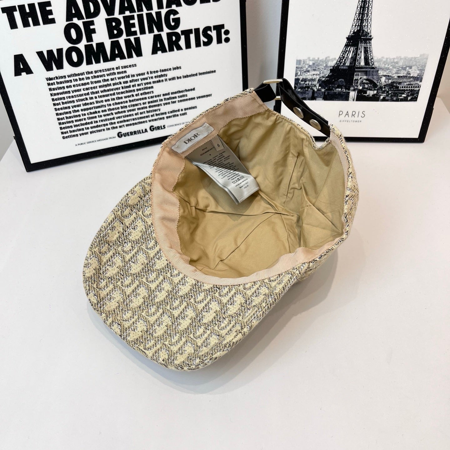 Dior cap with beige interior lining exposed, showing inner label and strap.