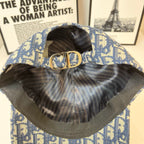 Dior cap interior with adjustable strap and gold CD clasp; blue monogram exterior.