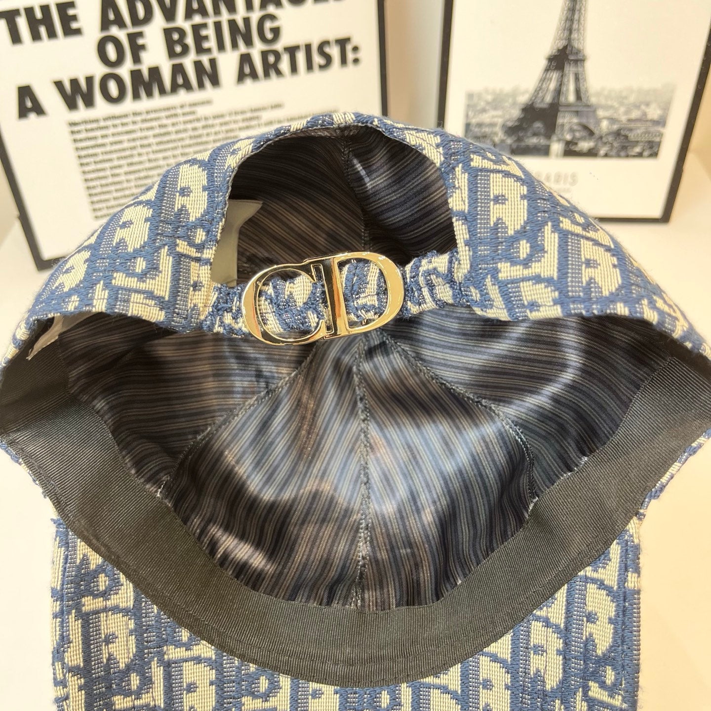 Dior cap interior with adjustable strap and gold CD clasp; blue monogram exterior.