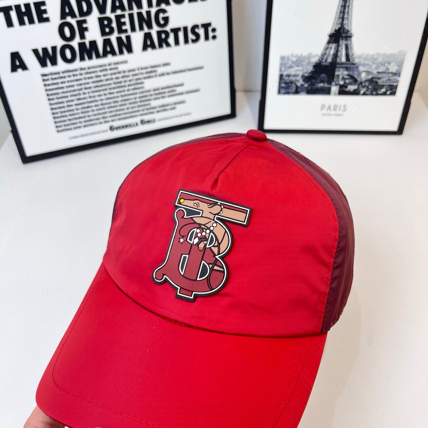 Red baseball cap with large front embroidered logo on crown