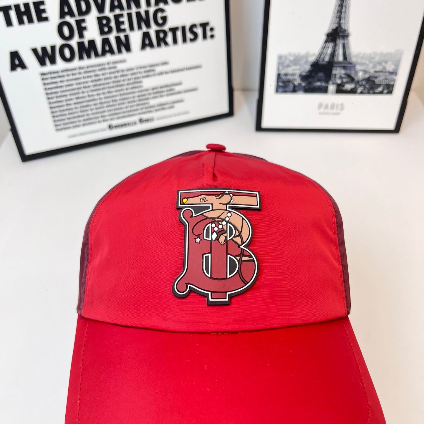 Red baseball cap with front embroidered monogram logo on crown