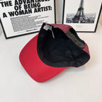 Red baseball cap turned inside-out, showing black interior and strap
