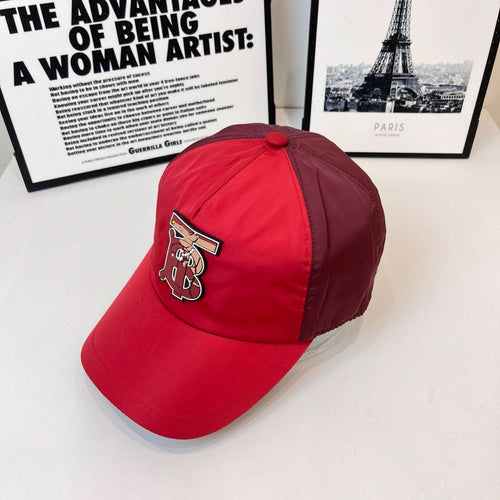 Red baseball cap with side embroidered monogram logo and curved brim