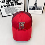 Red baseball cap with front embroidered monogram logo and curved brim