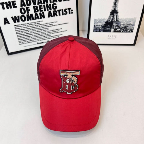Red baseball cap with front embroidered monogram logo and curved brim