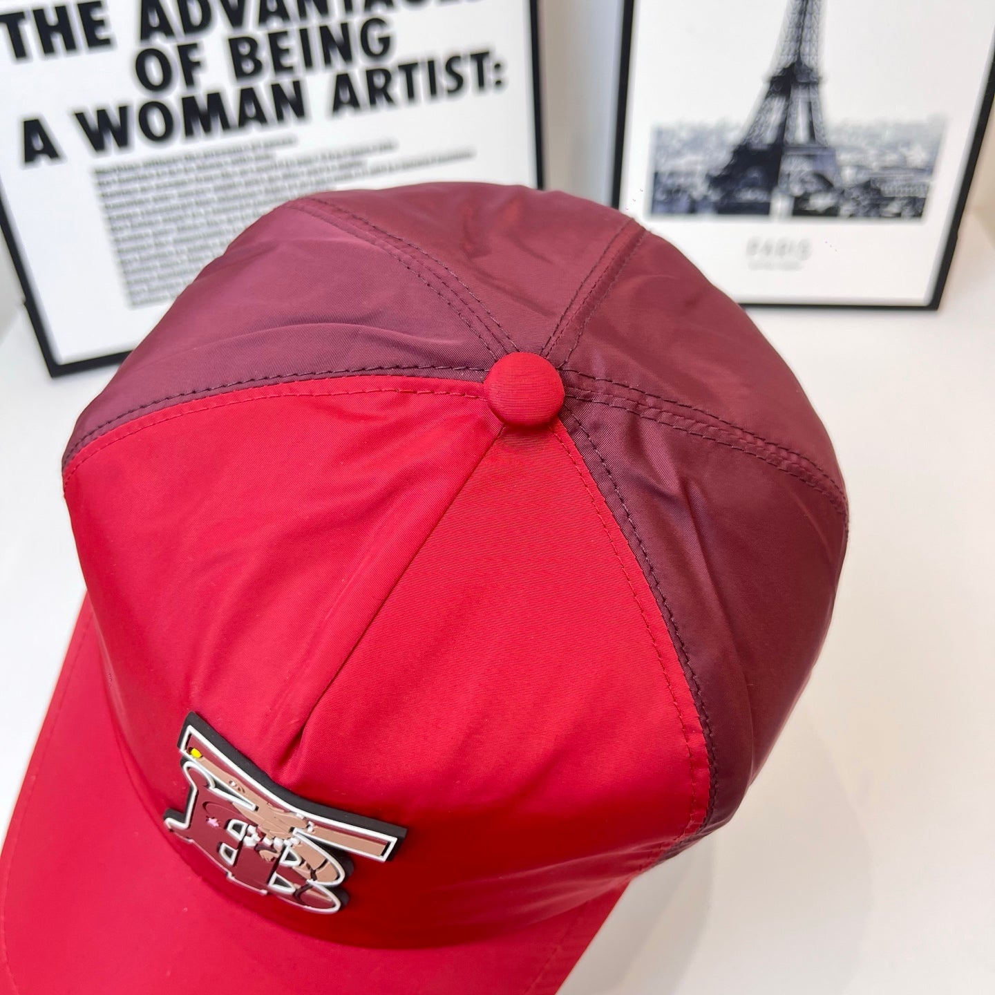 Red baseball cap showing crown seams and round button top