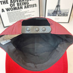 Red cap interior with black lining and adjustable eyelets strap