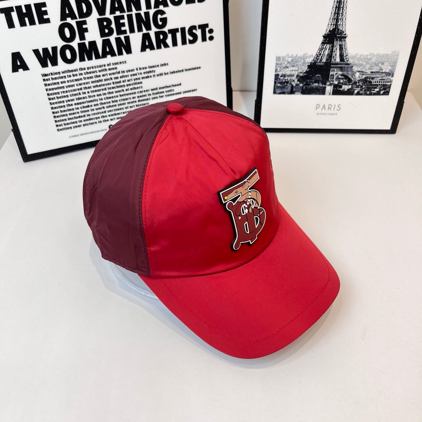 Red baseball cap with front logo patch and curved brim