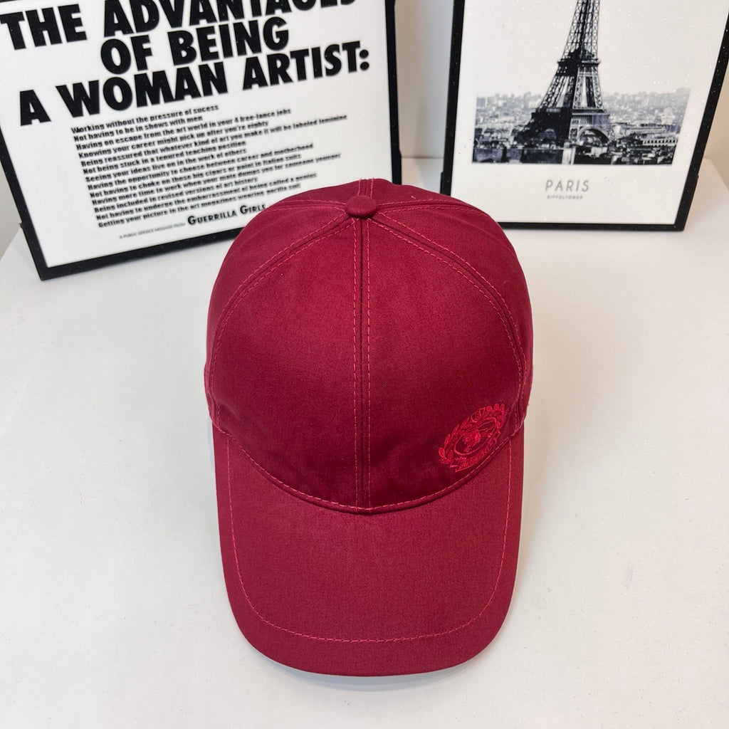 Burberry red cap with curved brim and small embroidered crest on the front