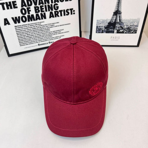 Burberry red cap with curved brim and small embroidered crest on the front