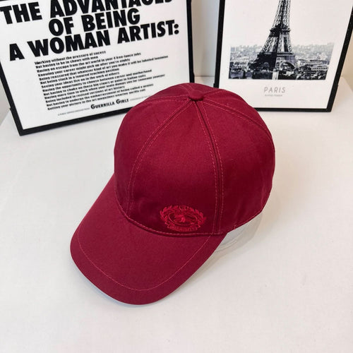 Burberry red cap, side view with embroidered crest patch near the brim