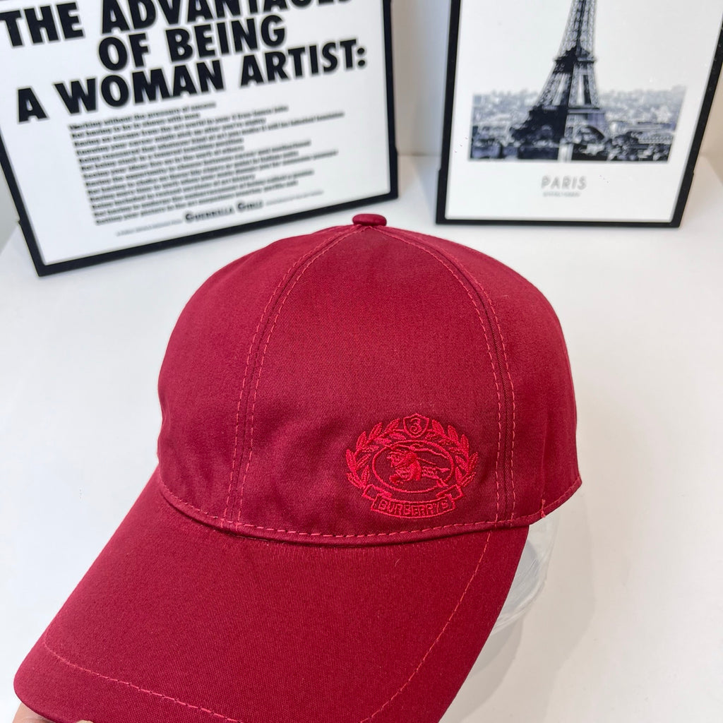 Burberry red cap with embroidered crest centered on the front panel