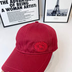 Burberry red cap with embroidered crest centered on the front panel
