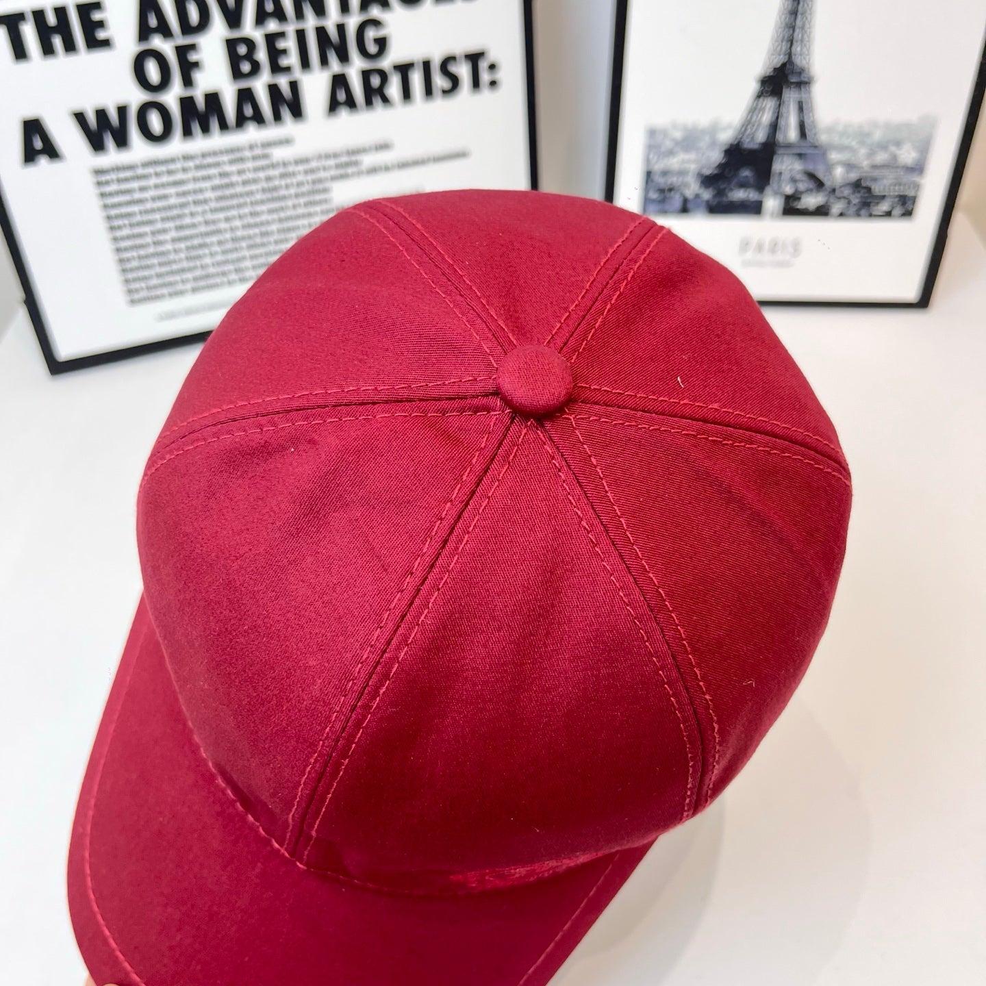 Burberry red cap back view with stitched crown and round fabric button