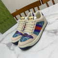 Cream Gucci unisex sneakers with blue, purple, and red web stripe side panels