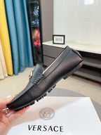 Black leather loafer with side seam stitching and gold-toned hardware