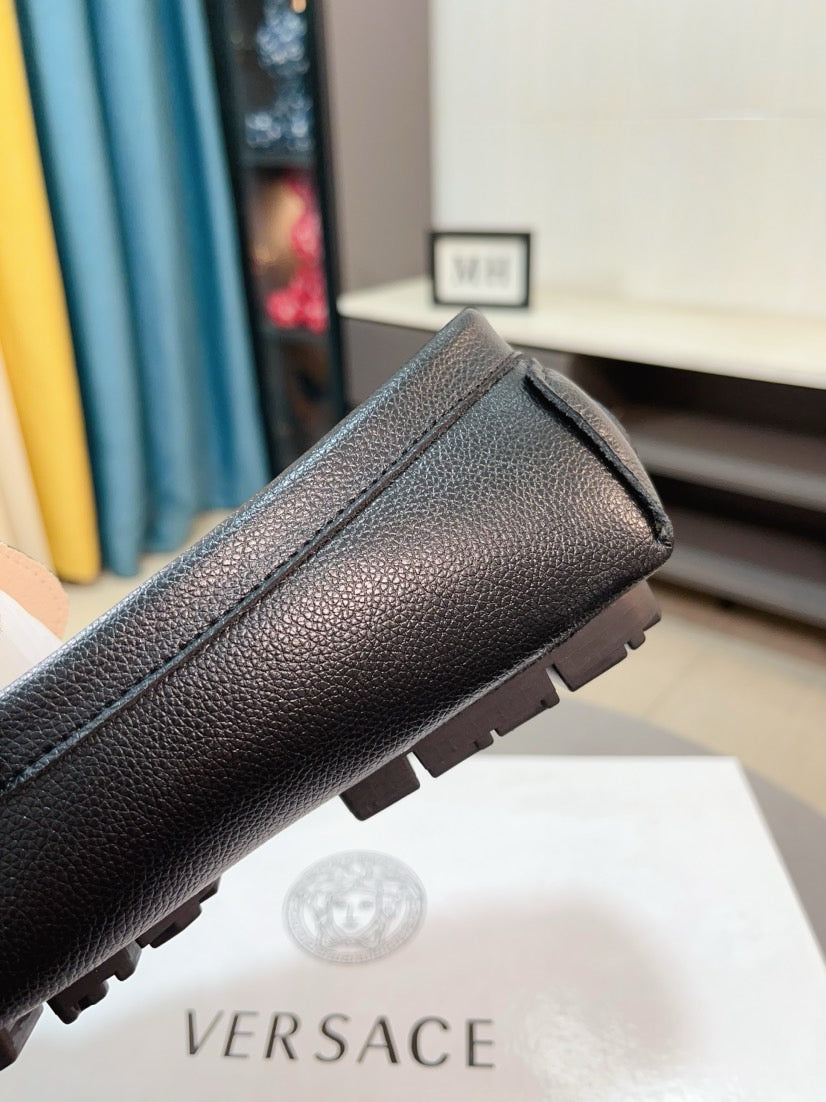 Black leather loafer with chunky rubber sole and moc-toe style seam