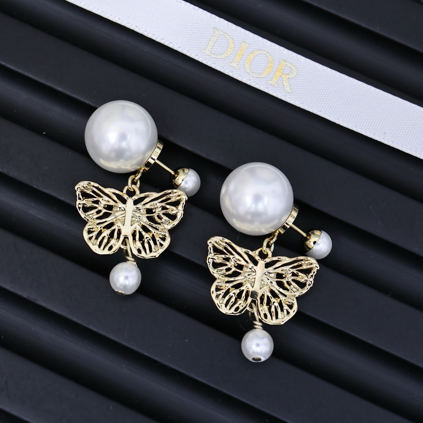 Dior gold tone dangling earrings with round white pearls