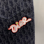 Dior patterned shorts with colorful 'Dior' script embroidery on thigh