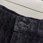 Dior emblem button on dark patterned shorts waistband