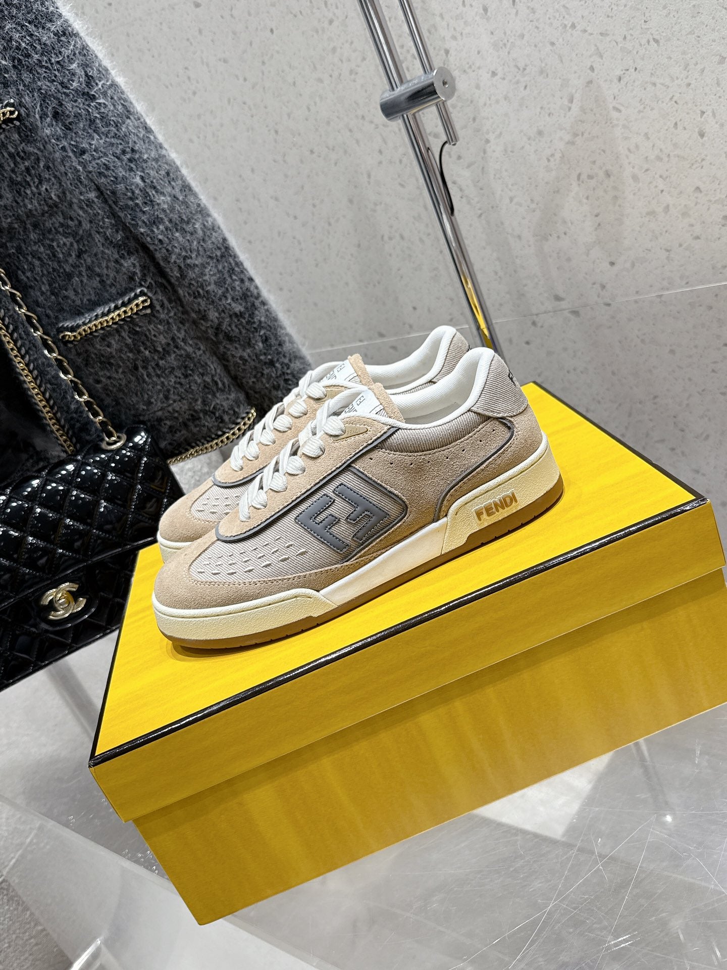 Fendi unisex sneakers with beige uppers, dark logo panel, white lace-up front