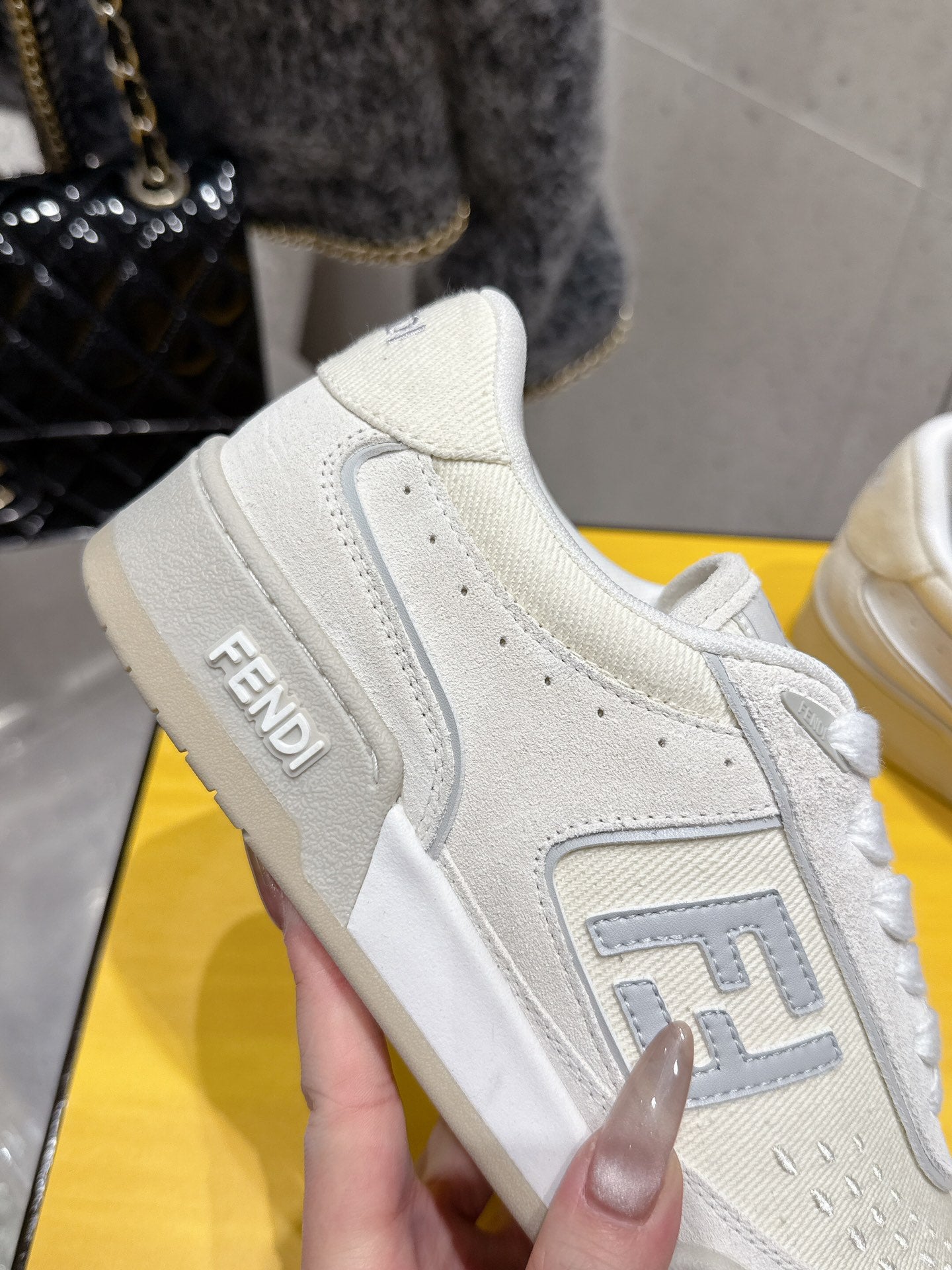 Fendi unisex sneakers, white leather, close-up of side panel with logo detail