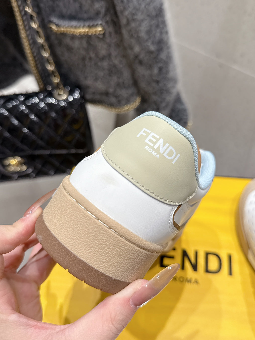 Fendi unisex sneakers heel close-up with FENDI Roma logo patch on tan panel