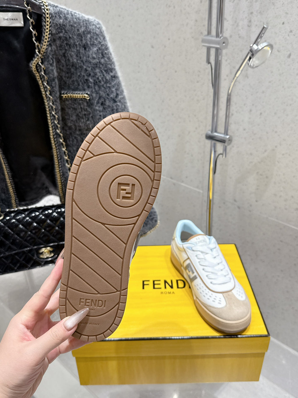 Fendi unisex sneakers outsole view, textured tan rubber tread with Fendi marking